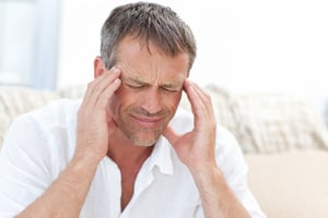 Man having a headache at home