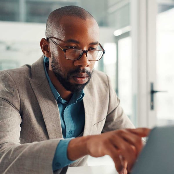 businessman-with-laptop-serious-and-financial-analysis-on-web