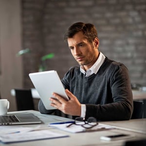 male-entrepreneur-using-digital-tablet-while-working-in-the-office