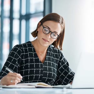 woman-and-laptop-writing-for-proposal