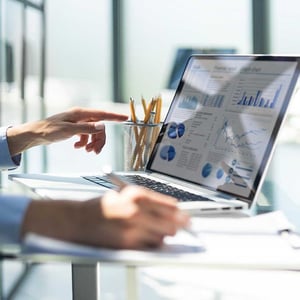 young-businessman-typing-computer-laptop-with-graph-chart-for-work-