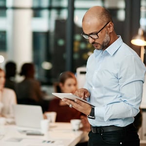 mature-businessman-using-digital-tablet-during-team-meeting